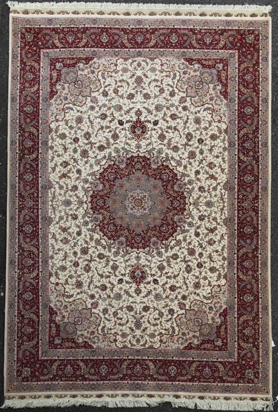 A modern Turkish Tabriz style part silk carpet, 9ft 10in by 6ft 8in.